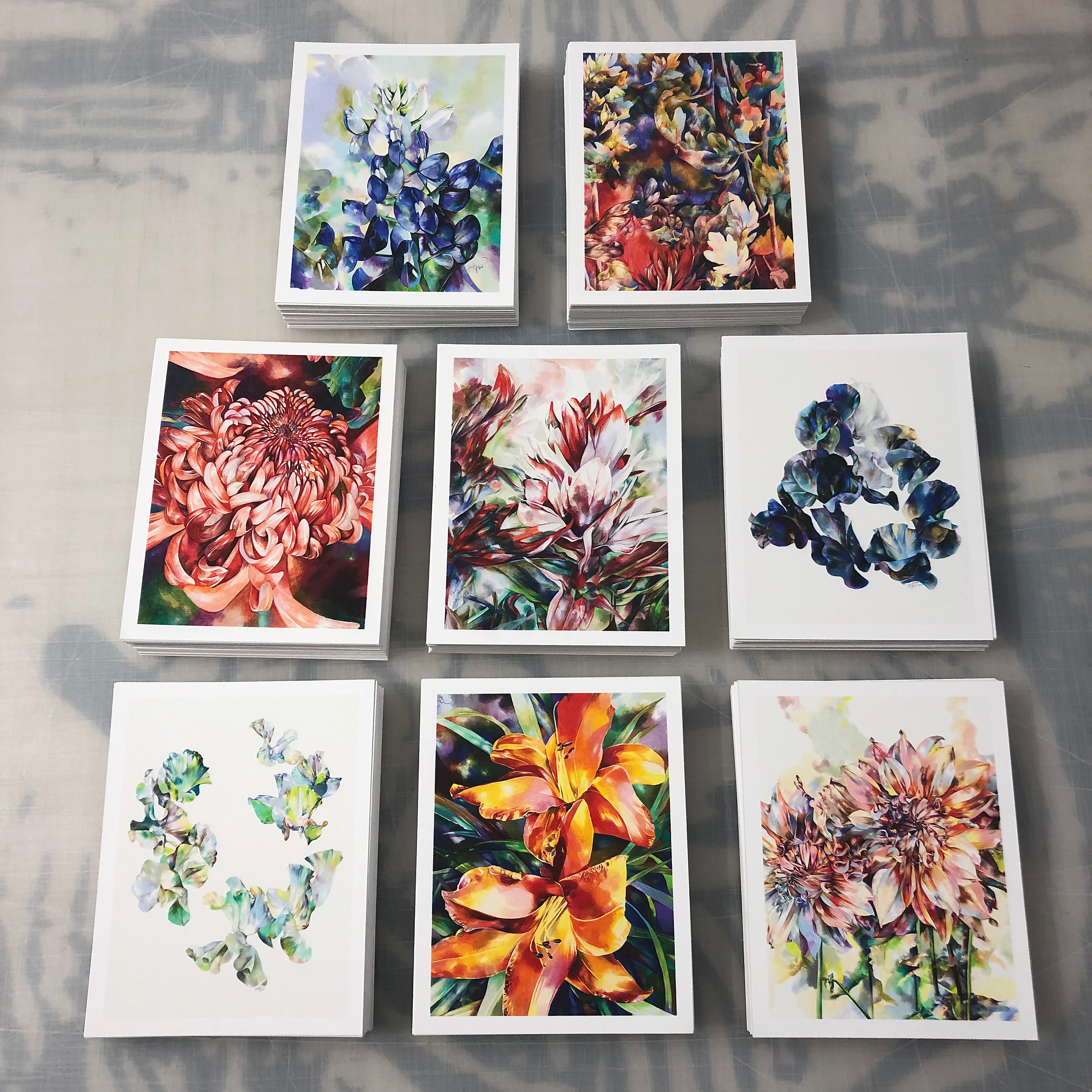 Stacks of card size prints of floral artwork by Virginia artist Zoe Jarvis.