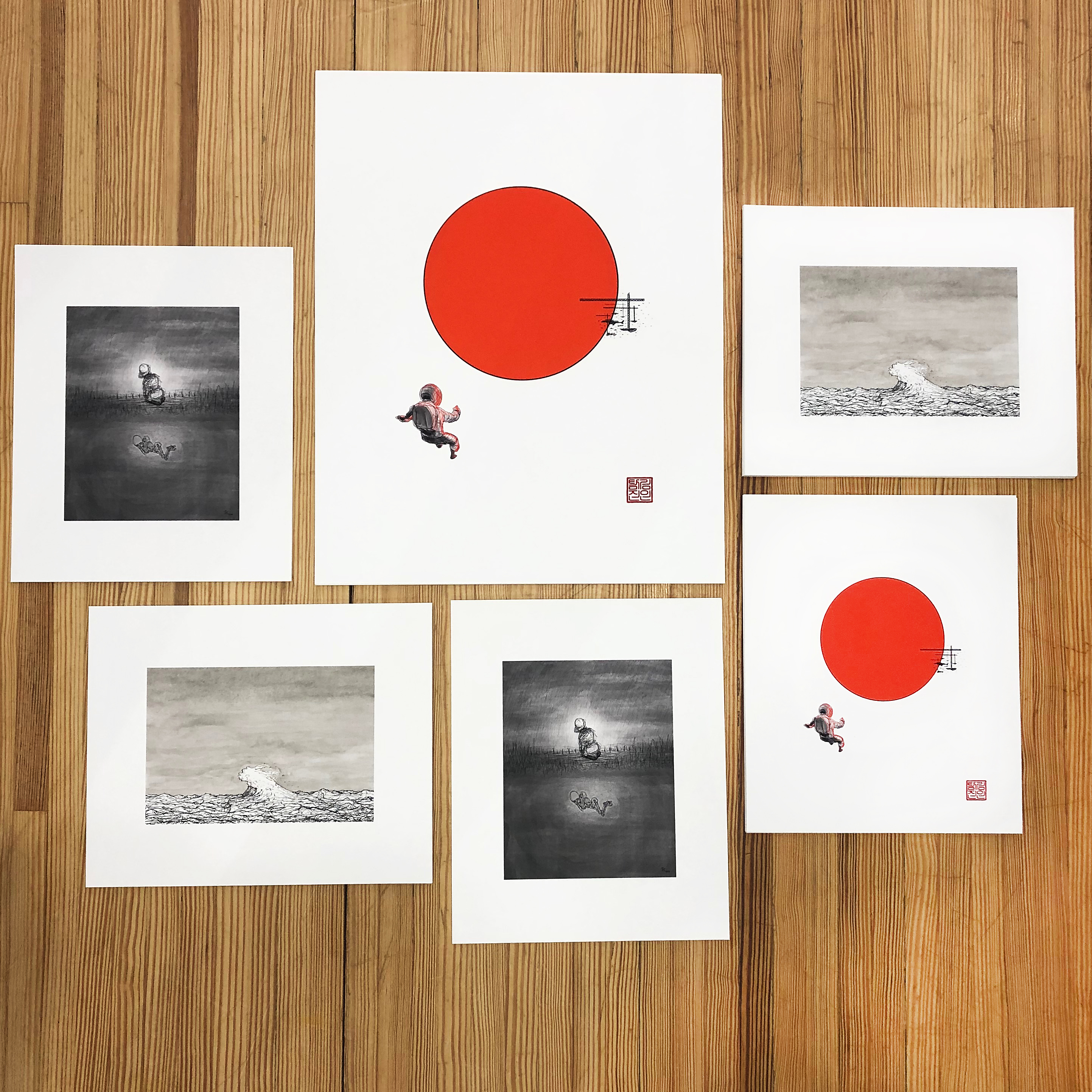 Multiple images and sizes of prints laid out on our studio table