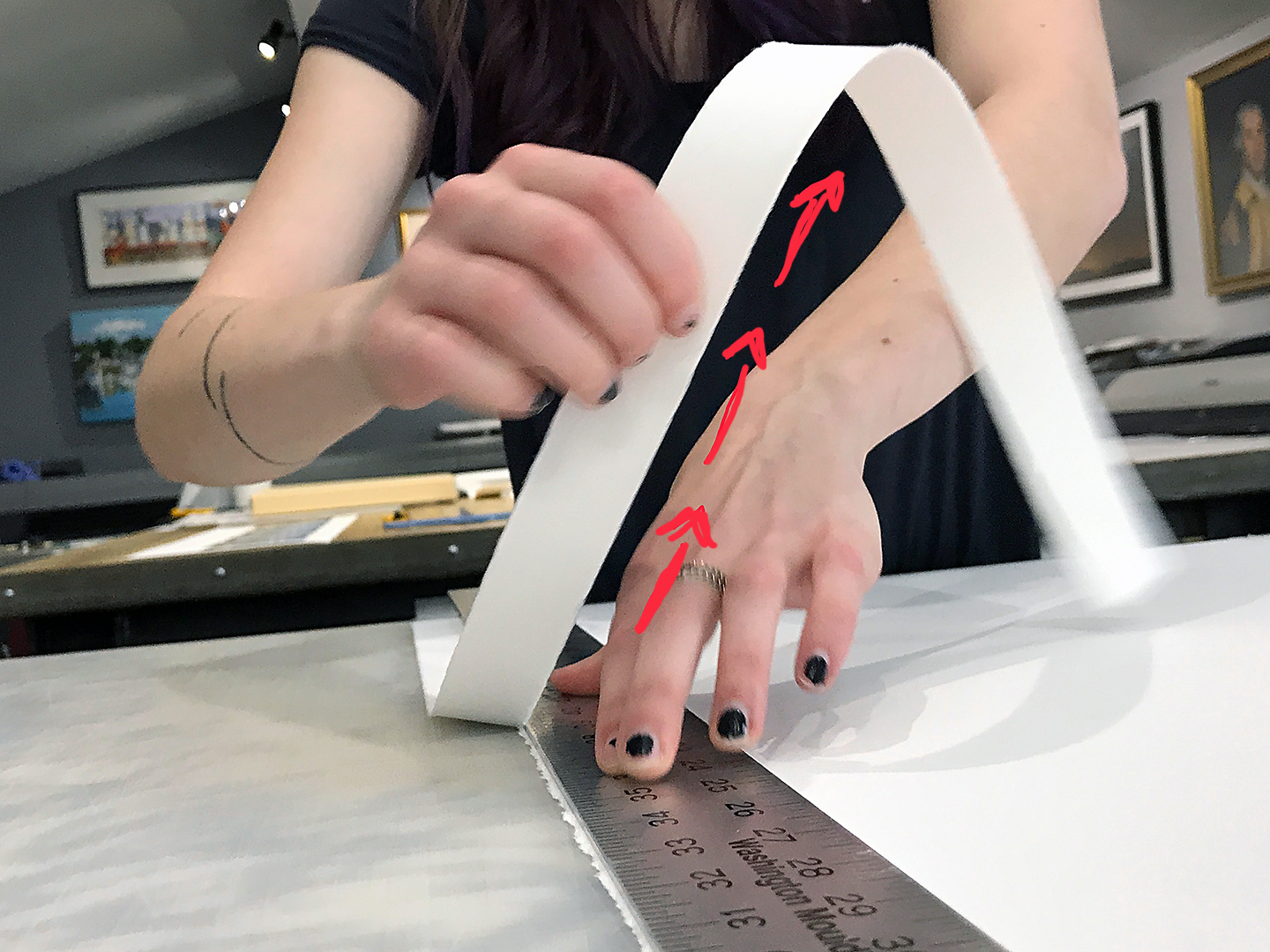 The process of hand tearing prints along a ruler