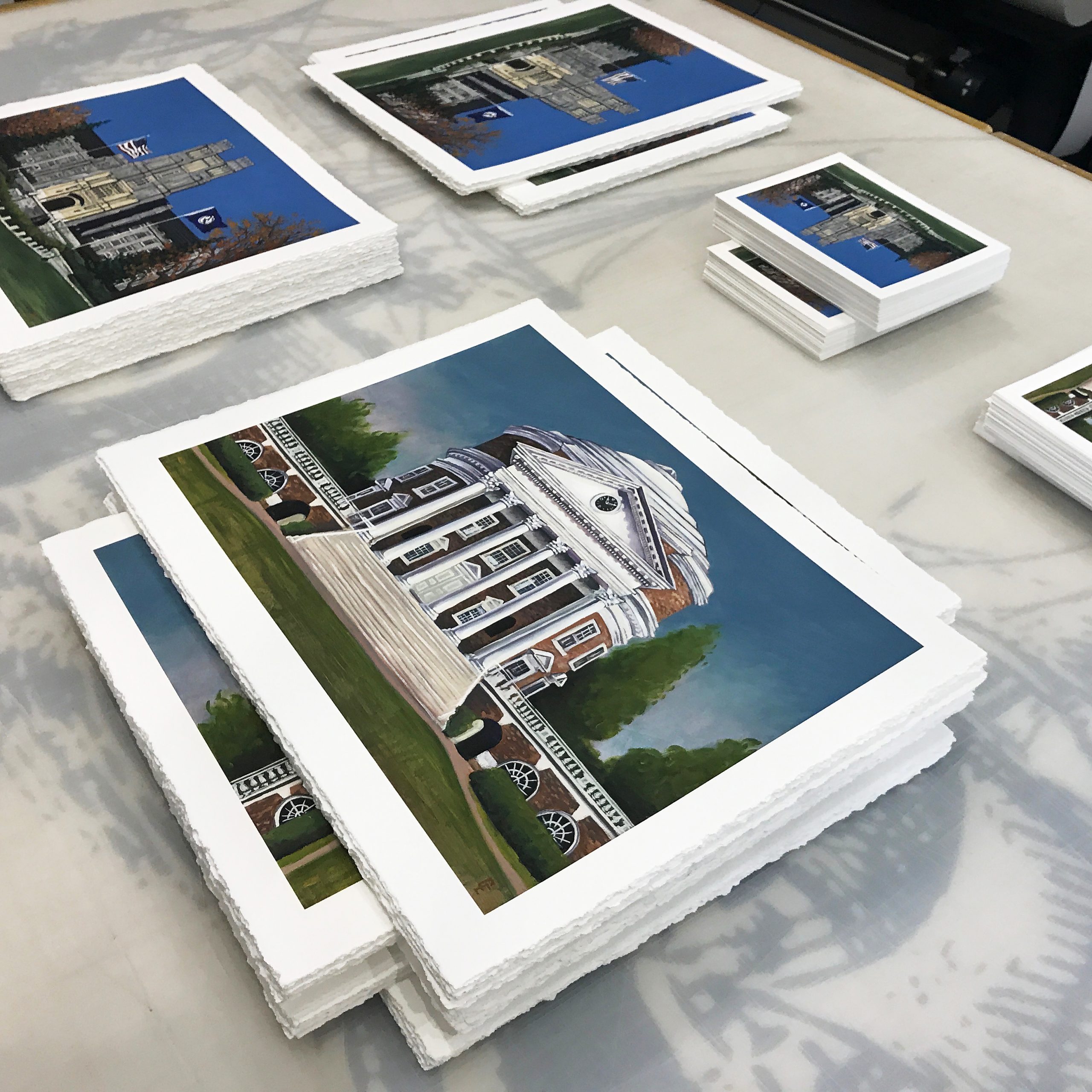 Stacks of digital fine art prints with a hand torn edge, made in our Northern Virginia studio.