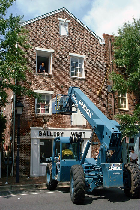 A crane lifts an IRIS printer to the third floor window of our old studio.