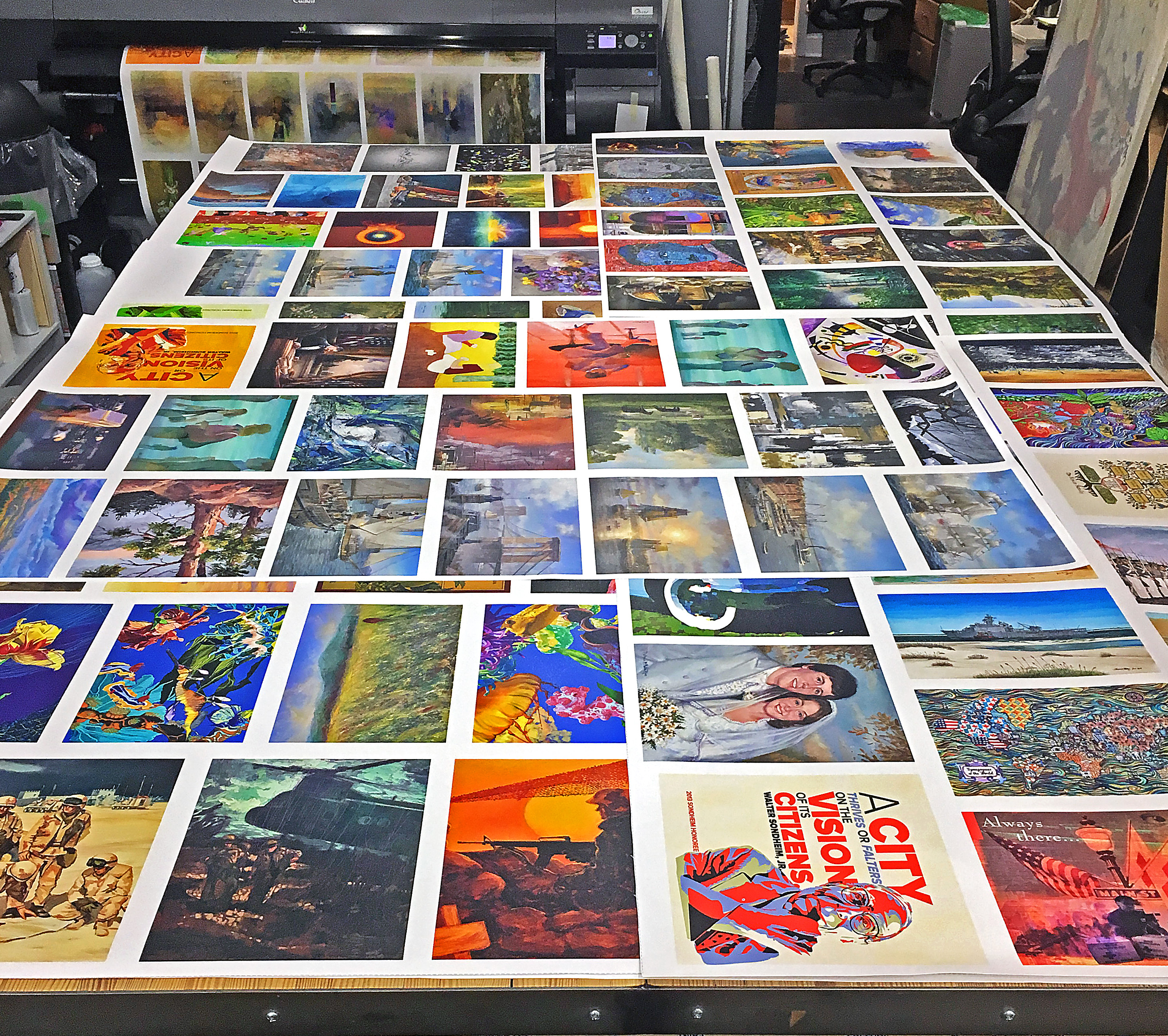 Quality printmaking requires color control - table full of proofs for color reference